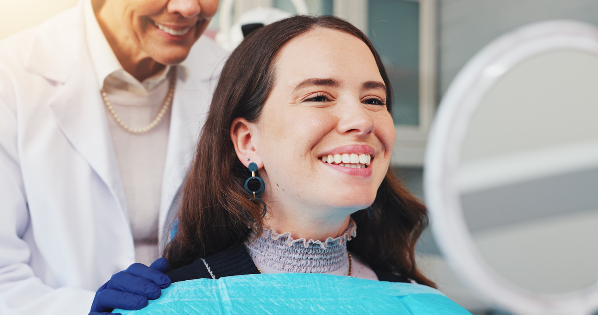 Teeth, smile and mirror with woman at dentist for dental care, treatment and fresh breath. Cleaning, tooth whitening and happy person for oral hygiene, orthodontics or wellness with veneer inspection